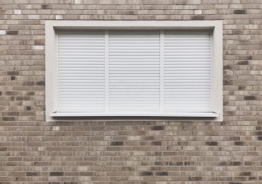 Window with closed roller shutter blinds